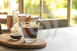 Iced cold brew coffee on wood tray