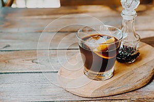 Iced cold brew coffee on wood tray