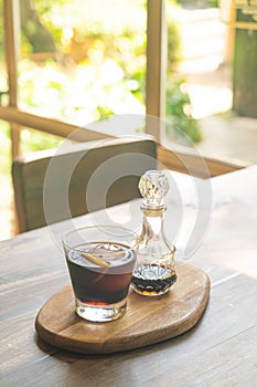 Iced cold brew coffee on wood tray