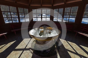 Iced fountain of thermal water inside a gazebo