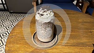 iced frappe chocolate drink with whipped cream on top and grated chocolate crunch