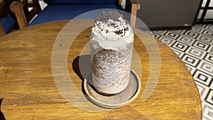 iced frappe chocolate drink with whipped cream on top and grated chocolate crunch