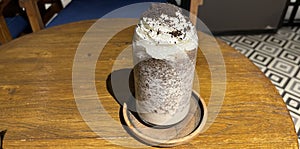 iced frappe chocolate drink with whipped cream on top and grated chocolate crunch