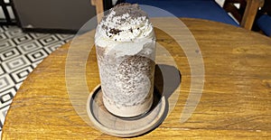 iced frappe chocolate drink with whipped cream on top and grated chocolate crunch