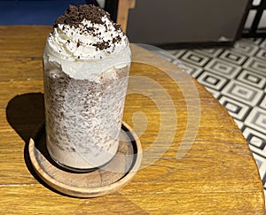 iced frappe chocolate drink with whipped cream on top and grated chocolate crunch