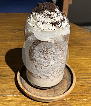 iced frappe chocolate drink with whipped cream on top and grated chocolate crunch