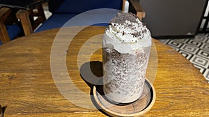 iced frappe chocolate drink with whipped cream on top and grated chocolate crunch