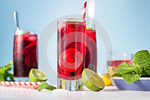 Iced hibiscus tea karkade, red sorrel, Agua de flor de Jamaica or lemonade with raspberries, blackberries, mint and citrus. photo