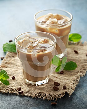 Iced latte coffee in a glass with cold milk. Summer drink