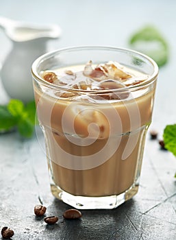 Iced latte coffee in a glass with cold milk. Summer drink