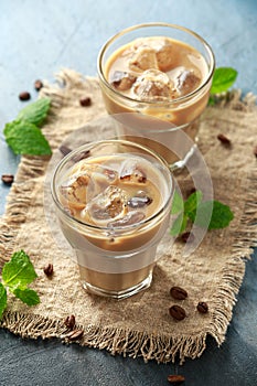 Iced latte coffee in a glass with cold milk. Summer drink