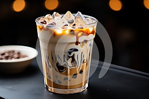 Iced Latte Coffee with Milk Mixture in Clear Glass Served in Black Table at Cafe