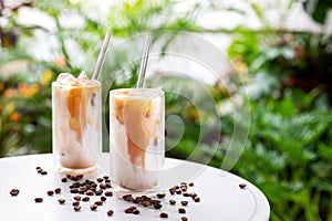 Iced latte coffee on white table