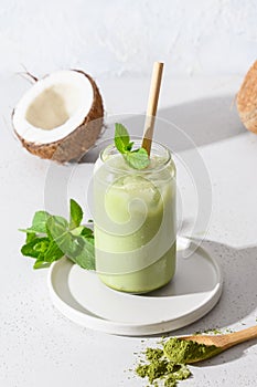 Iced latte green matcha tea with coconut milk garnish mint on white background