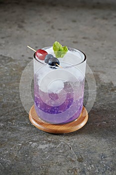 Iced lemon sparking juice with pastel colour jelly.