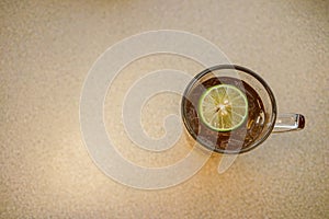 Iced lemon tea with sliced lime contains in glass