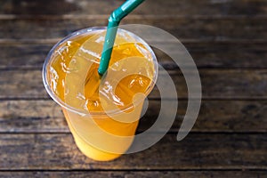 Iced orange tea on rustic wood table