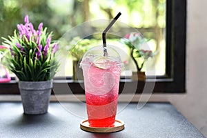 iced red raspberry punch cocktail with lime in glass on bar counter beverage shop background. summer drink.