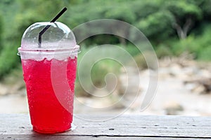 Iced red soda in a plastic cup