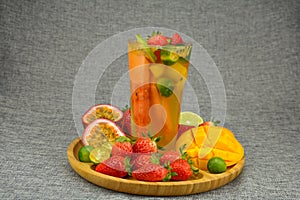 iced tea with fruits in a glass with various fruits cut
