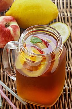 Iced tea with lemon and peach in a Mason jar