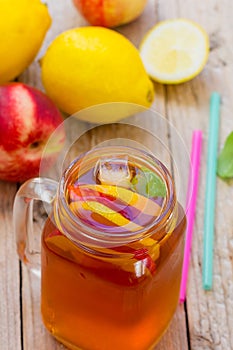 Iced tea with lemon and peach in a Mason jar
