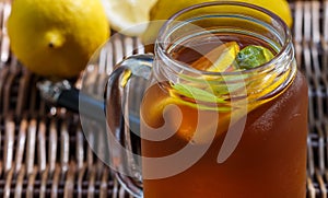 Iced tea with lemon and peach in a Mason jar