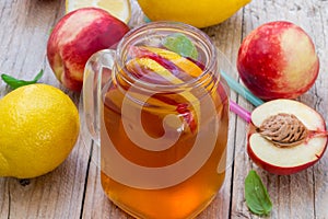 Iced tea with lemon and peach in a Mason jar