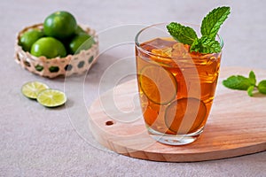 Iced tea with lime and mint leaf