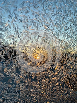 Iceflowers, frozen.The ice-cold frost forms ice crystals in beautiful unique patterns on the window, Hood and wiper on the Car