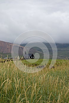 Iceland Black Church in distance on a green field