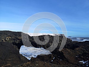 Iceland. Brown basaltic rocks and the sea