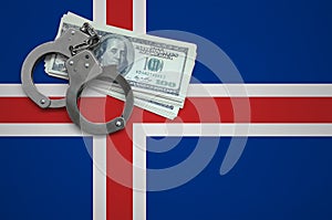 Iceland flag with handcuffs and a bundle of dollars. The concept of breaking the law and thieves crimes
