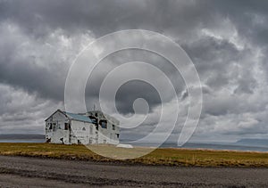 Iceland Landscape with Lonely Building. Cloudy Blue Sky