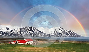 Iceland landspace mountain with rainbow photo