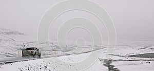 Iceland - October 2, 2012: Cars circulating on snowy tracks during a winter storm