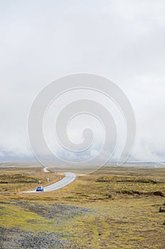 Iceland - September , 2014 -Fog road in iceland western part, mist cloudy road, with yellow grass.