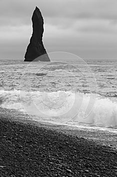 Iceland. South area. Vik. Reynisdrangur rock pinacle and Atlantic Ocean