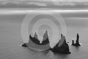Iceland. South area. Vik. Reynisdrangur rock pinacles and Atlantic Ocean photo