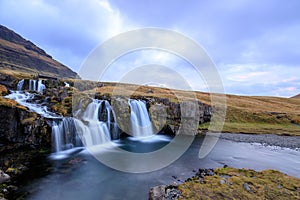 Iceland timelapse photography of waterfall and famous mountain. Kirkjufellsfoss and Kirkjufell in northern Iceland nature