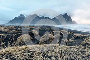 Iceland, Vestrahorn mount and black sand over the ocean. photo