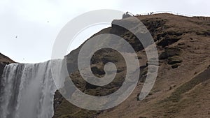 Iceland waterfall Skogafoss in beautiful Icelandic landscape.