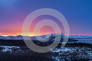 Iceland winter landscape, snowy mountain, blue and pink sky, sunset or sunrise, empty space above