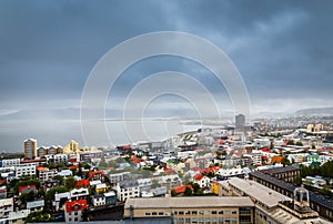 Icelandic capital panorama, streets and colorful resedential buildings with ocean fjord in the background, Reykjavik, Iceland