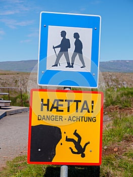 Icelandic Danger sign falling off cliff and hikers