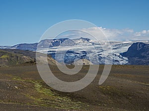 Icelandic landscape with eyjafjallajokull glacier tongue, Markarfljot river and green hills. Fjallabak Nature Reserve