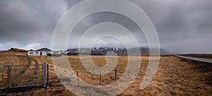 Icelandic landscape at winter. Farmland, farmhouse stormy cloudy sky Iceland europe