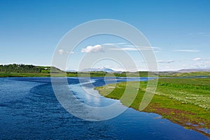 Icelandic scenery with salmon river, mountains in the background