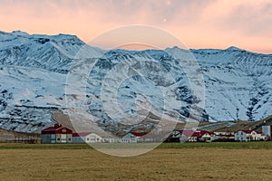 The Icelandic village of Thorvaldseyri with the infamous eyjafjallajokull volcano behind at sunrise