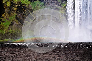 Icelandic waterfall Skogafoss, part of it with a rainbow